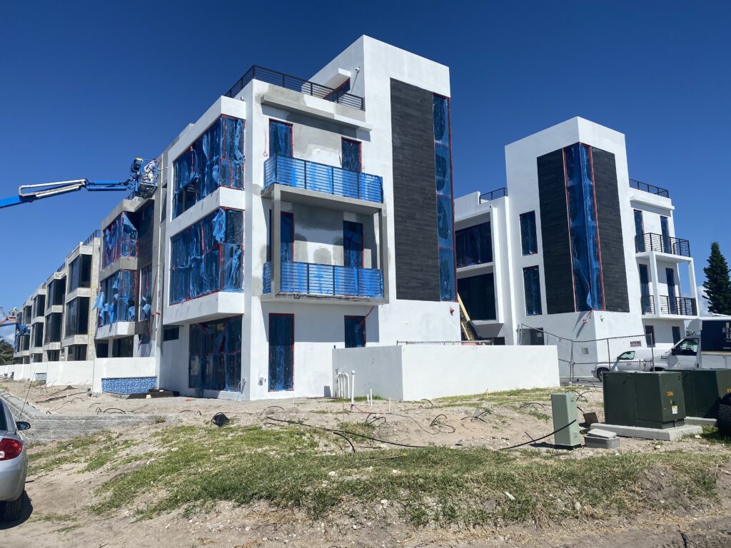 white building and blue with painter